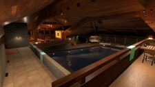 The view of a large indoor pool within the house. There are comfort areas for players to lay and rest